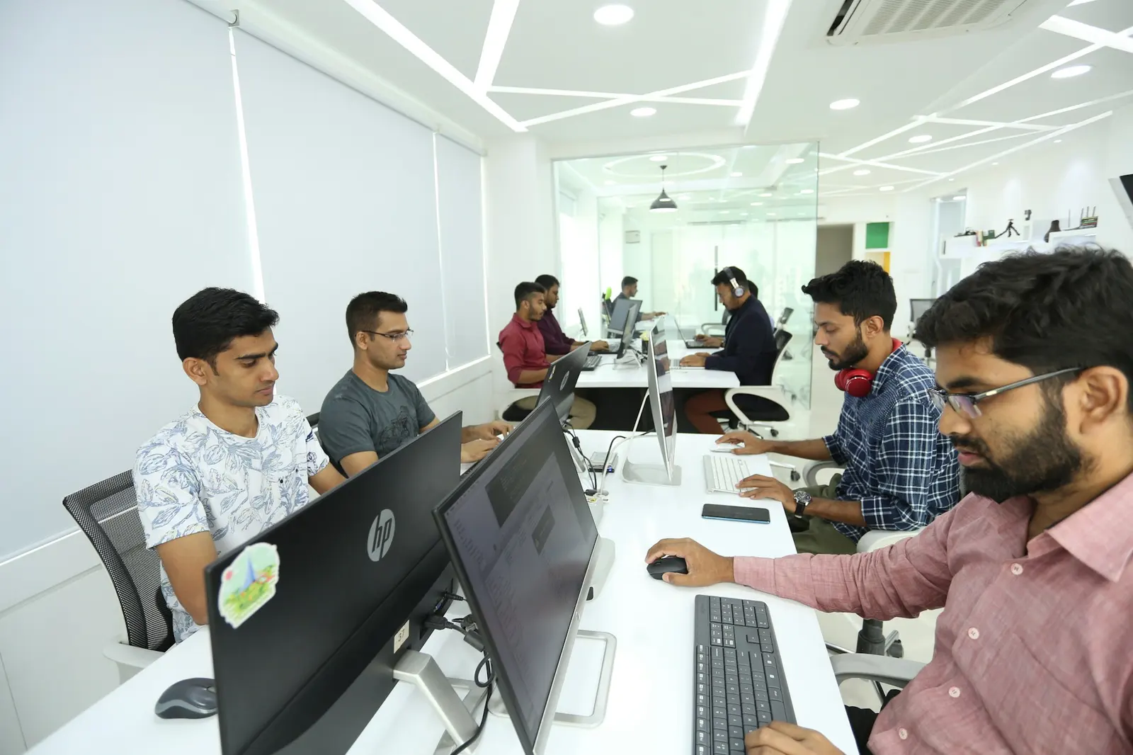 Team working on computers in a bright office