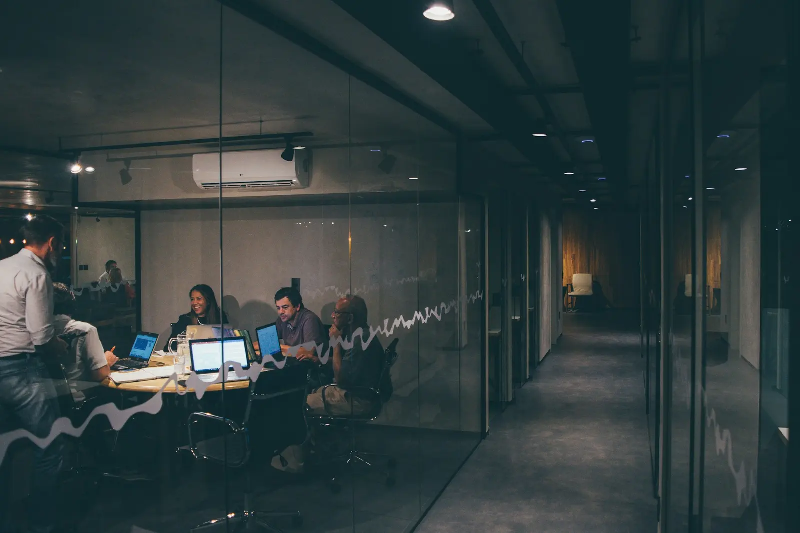 Business meeting in a modern glass-walled office